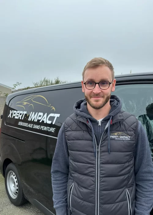 a man standing in front of a black van